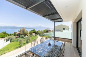 a dining room with a view of the water at Solmare Loft Suite in Nikiana