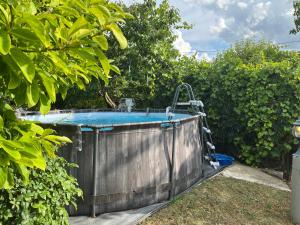 a hot tub in a garden next to some bushes at Apartma Lavanda in Koper