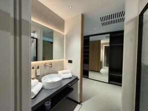 a bathroom with a sink and a mirror at Hotel Lido in Ledro +65 photos
