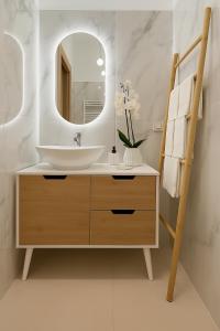 a bathroom with a sink and a mirror at Sea Pearl Luxury Rooms in La Spezia +45 photos