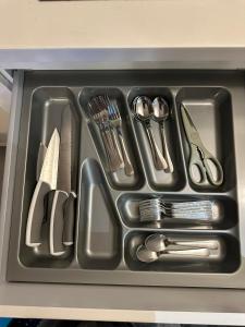 a tray filled with utensils in a drawer at Spacious Duplex, Netflix and Various Facilities Pool KL view at i-City Shah Alam in Shah Alam