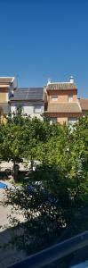 a view of a building with trees and buildings at A Beautiful Townhouse in Rute