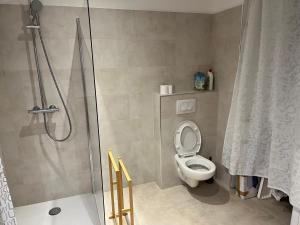 a bathroom with a shower with a toilet and a shower curtain at T2 - Marine de sant ambroggio, LUMIO 20260 in Lumio