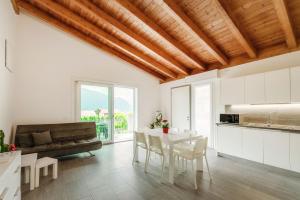 a kitchen and living room with a table and chairs at Casa Malù in Mandello del Lario