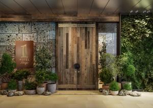 a front door of a building with potted plants at 1 Hotel Tokyo in Tokyo
