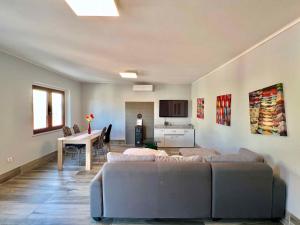 a living room with couches and a table and a kitchen at Holiday home in Bribir 41512 in Bribir