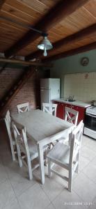 a white table and chairs in a kitchen with a table and a table at Entrepinos I in Juana Koslay  +14 photos