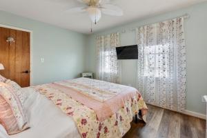 a bedroom with a bed and a ceiling fan at Rose Cottage in Rodanthe