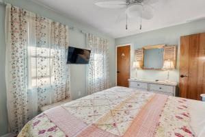 a bedroom with a large bed and a window at Rose Cottage in Rodanthe