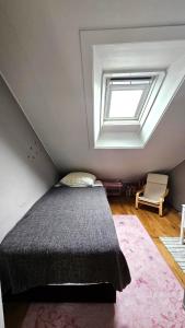 a bedroom with a bed and a window at Your Icelandic home in Reykjavik in Reykjavík +1 photo