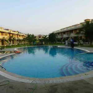 a large pool of blue water in a courtyard at Beachside luxury getaway in Cana +4 photos