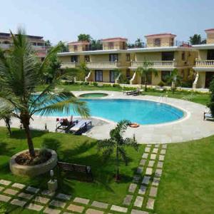 a swimming pool with a palm tree in front of a building at Beachside luxury getaway in Cana