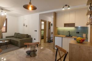 a kitchen and living room with a couch and a table at 4REST Tara in Bajina Bašta