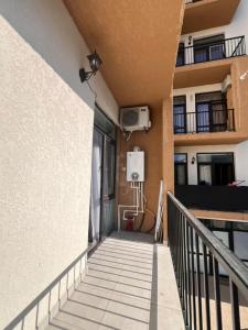 a staircase leading up to a building with a balcony at Comfort class apartment 10 in Kutaisi