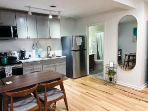 a kitchen with a table and a refrigerator at The Baker The Archive Lofts in Marion