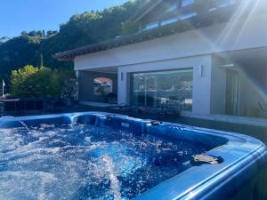 a hot tub in the backyard of a house at Villa Navalia in Menaggio