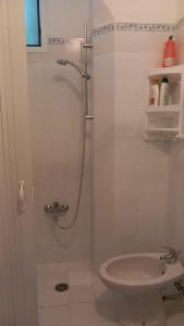 a bathroom with a shower with a toilet and a sink at La Casa di Tina in Ischia