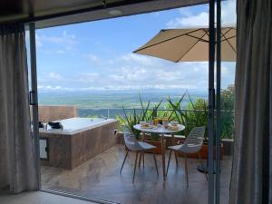 a bathroom with a tub and a table and chairs and a tub and a table at Glamping Jalisco in Buenavista