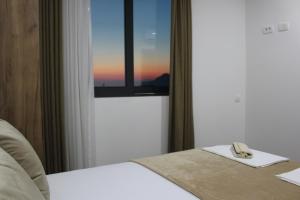 a hotel room with a bed and a window at AMD - stan 314 in Dobra Voda