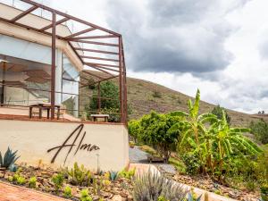 a house with a mountain in the background at Hotel Alma in Tinjacá +39 photos
