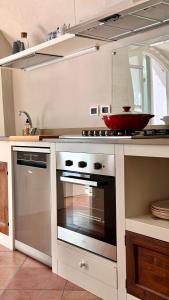 a kitchen with an oven with a bowl on top at Borgo dei Sogni - Deluxe Apartment with Terrace - Lago di Garda in San Felice del Benaco