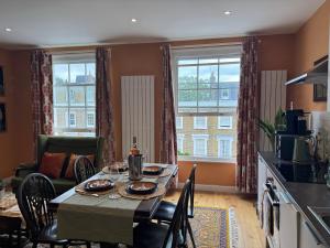 a kitchen and dining room with a table and chairs at Jett Joy in Moffat