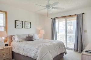 a bedroom with a bed and a ceiling fan at Seaside 46 in Nags Head