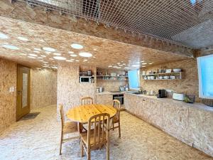 a dining room with a wooden table and chairs at Maison atypique, au coeur de Sainte Marine in Combrit