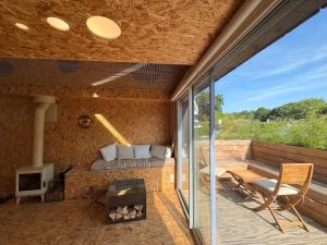 an outdoor living room with a couch and a fireplace at Maison atypique, au coeur de Sainte Marine in Combrit