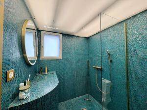 a bathroom with a shower and a sink and a mirror at Maison atypique, au coeur de Sainte Marine in Combrit +17 photos
