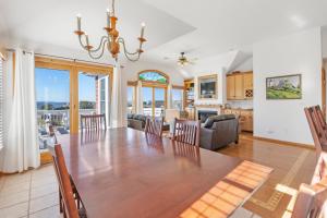 a dining room and living room with a table and chairs at Seawatch 5 in Nags Head