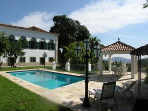 a house with a swimming pool and a gazebo at Casa Aprazível 5 in Rio de Janeiro