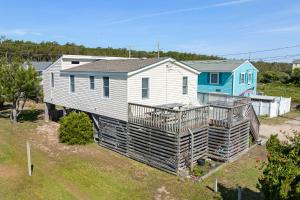 a home with a deck and a house at Seasons in the Sun in Nags Head