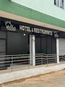 a hotel and restaurant sign on the side of a building at Hotel e Restaurante Casa Velha in Barra Longa