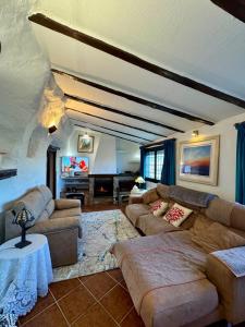 a living room with two couches and a table at Cueva Solaz Galera in Galera