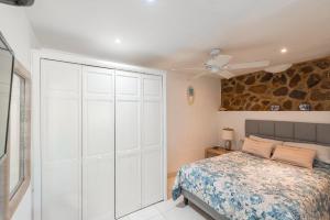 a bedroom with a white closet and a bed at Studio Bella in Philipsburg