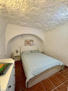 a bedroom with a bed in a white room at Cueva Solaz Galera in Galera +15 photos