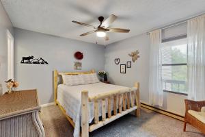 a bedroom with a bed and a ceiling fan at Misty Woods 03 in Sugar Mountain +19 photos