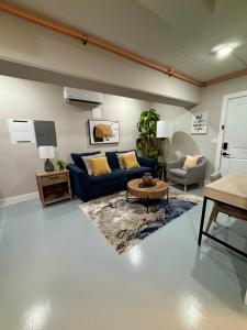 a living room with a blue couch and a table at The Monarch Unit 8 in Huntsville