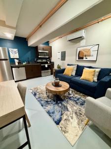 a living room with a blue couch and a table at The Monarch Unit 8 in Huntsville