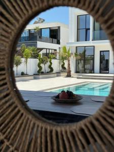 a view of a house with a bowl of fruit next to a pool at Soléa Villa in Rrushkull +81 photos