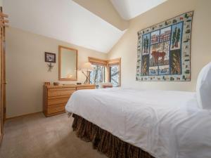 a bedroom with a large white bed and a dresser at RMR: Primrose 1711 Condo in The AspensWilsonWY in Wilson