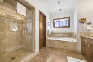 a bathroom with a shower and a tub and a sink at RMR: Timbers at Granite Ridge 3098 in Teton Village in Teton Village +43 photos