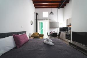 a bedroom with a bed with a stuffed animal on it at Elite luxury Suites in Omodos
