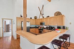 a kitchen with wooden cabinets and a wooden counter top at RMR: Moose Creek 17 Condo in Teton Village in Teton Village