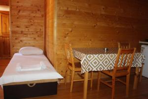 a dining room with a table and chairs in a cabin at Lotos - vikendica 1 in Bar