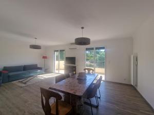 a living room with a table and a couch at Elomarisa in Grimaud