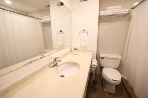 a white bathroom with a sink and a toilet at Victoria Inn in Ciudad Victoria +23 photos