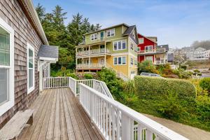 a balcony of a house with a wooden walkway at The Bellevue in Lincoln City