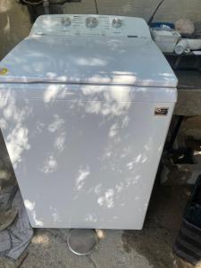 a white refrigerator sitting on the ground with its door open at Cativa CozyHomestay in Hermosillo